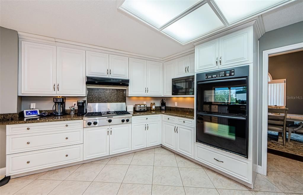 Double oven, one convection, microwave oven, gas cooktop with extensive exhaust system.
