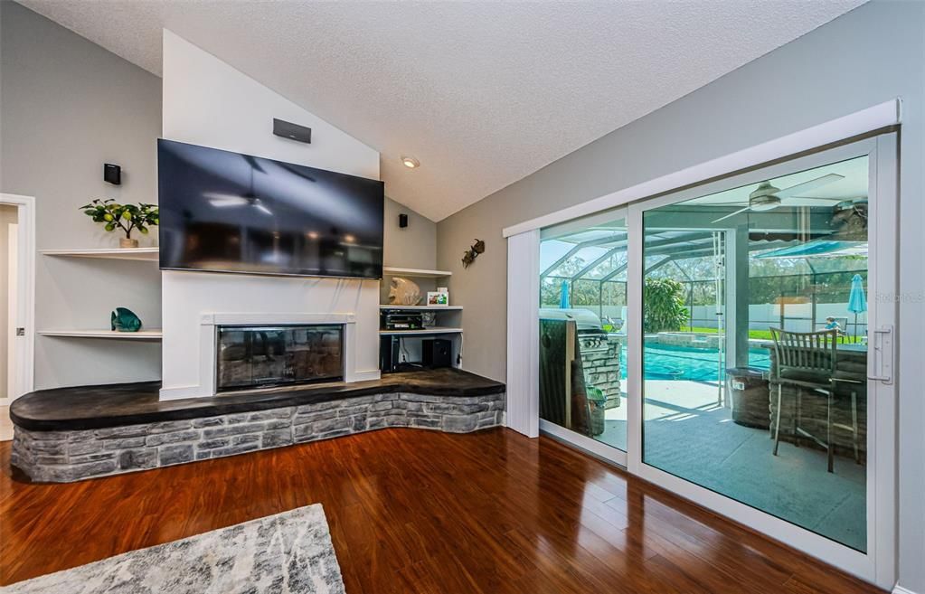 Family room with remodeled fireplace with new glass sliding doors to pool area.