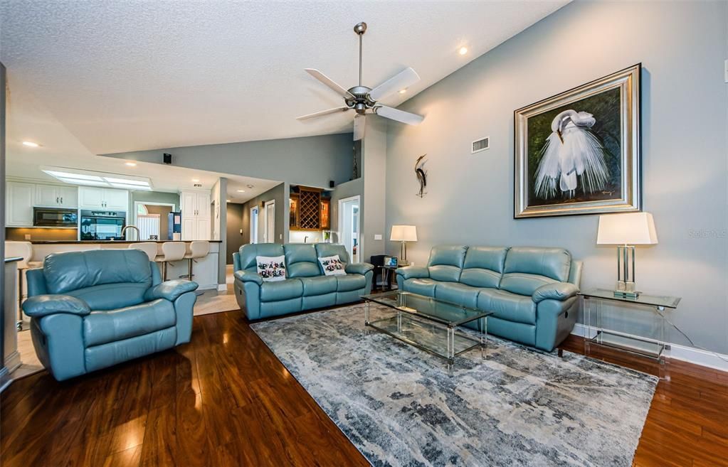 Spacious family room  with wood laminate flooring.