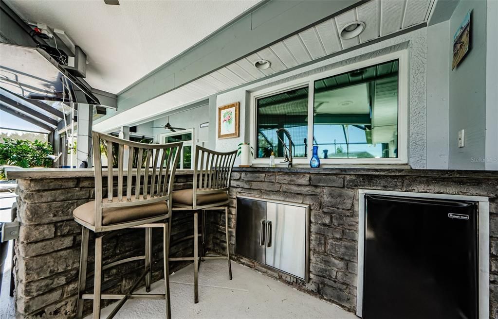 Part of outdoor kitchen at poolside.