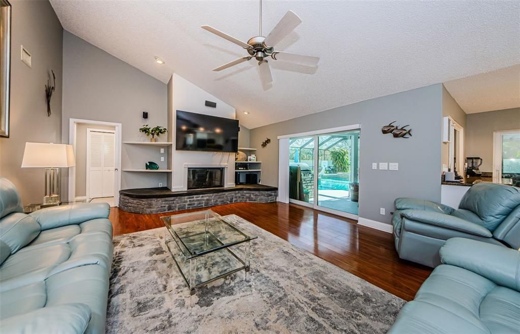 Large family room off kitchen with remodeled fireplace converted to gas.  New sliding doors to pool area.