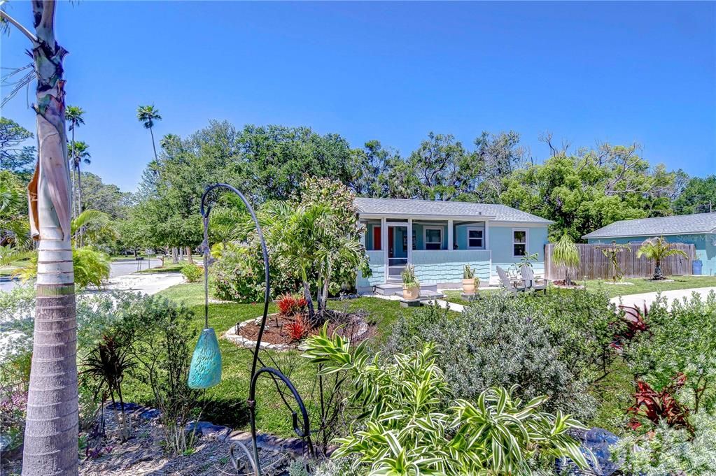 Enjoy lush and tropical landscaping in the front of the home