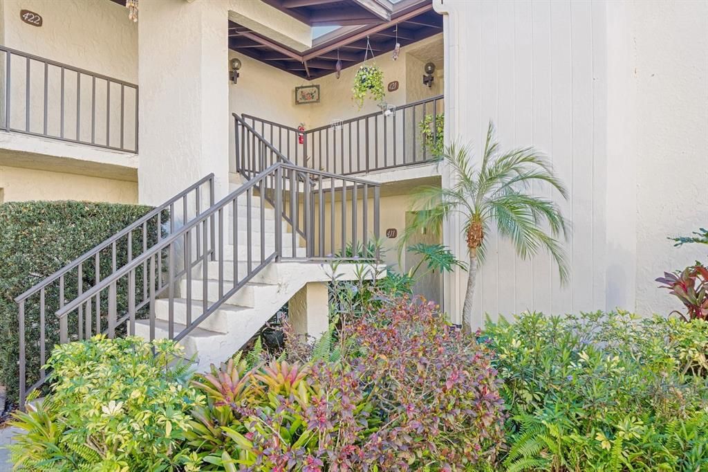 Building is surrounded by lush landscaping.