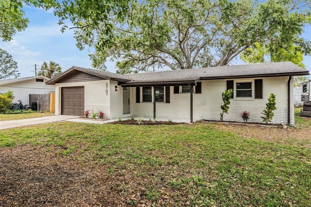 Freshly painted exterior with view of one car garage, spacious driveway and 2019 roof