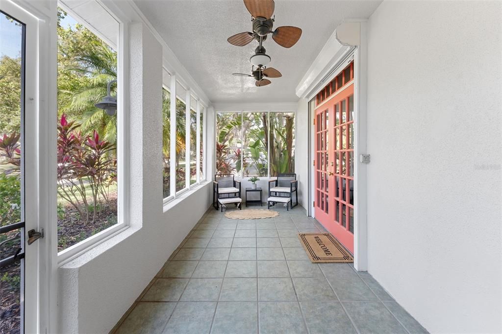 Covered and screened porch, perfect for greeting neighbors from