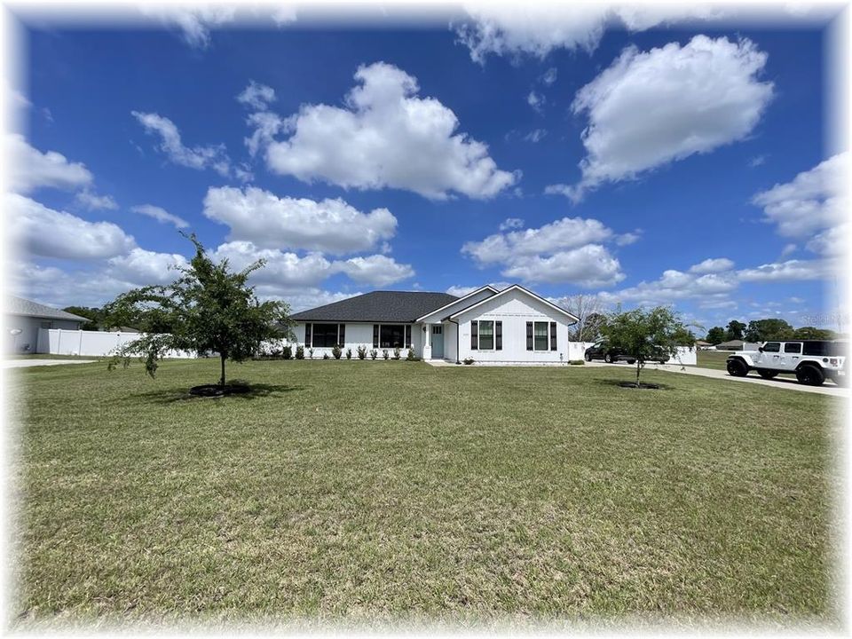 TRUE 4/2 SPLIT WITH DBL GARAGE - ON .56 AC!