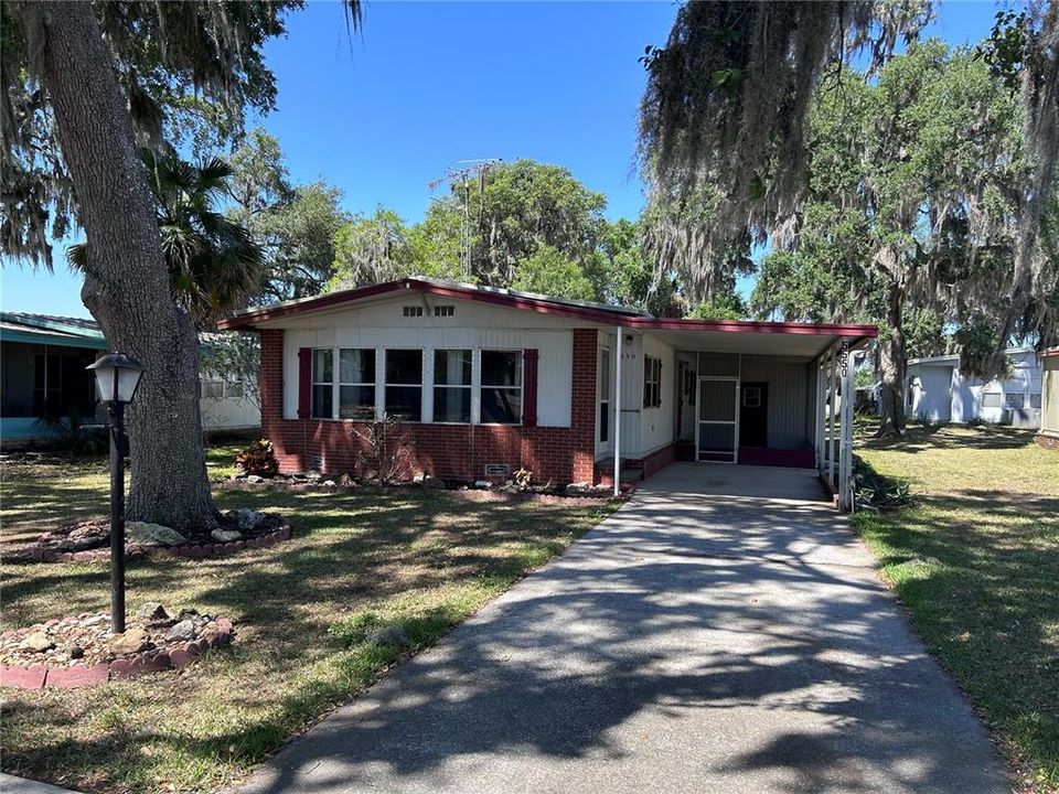 Nestled among the shade trees with windows all the way across the front