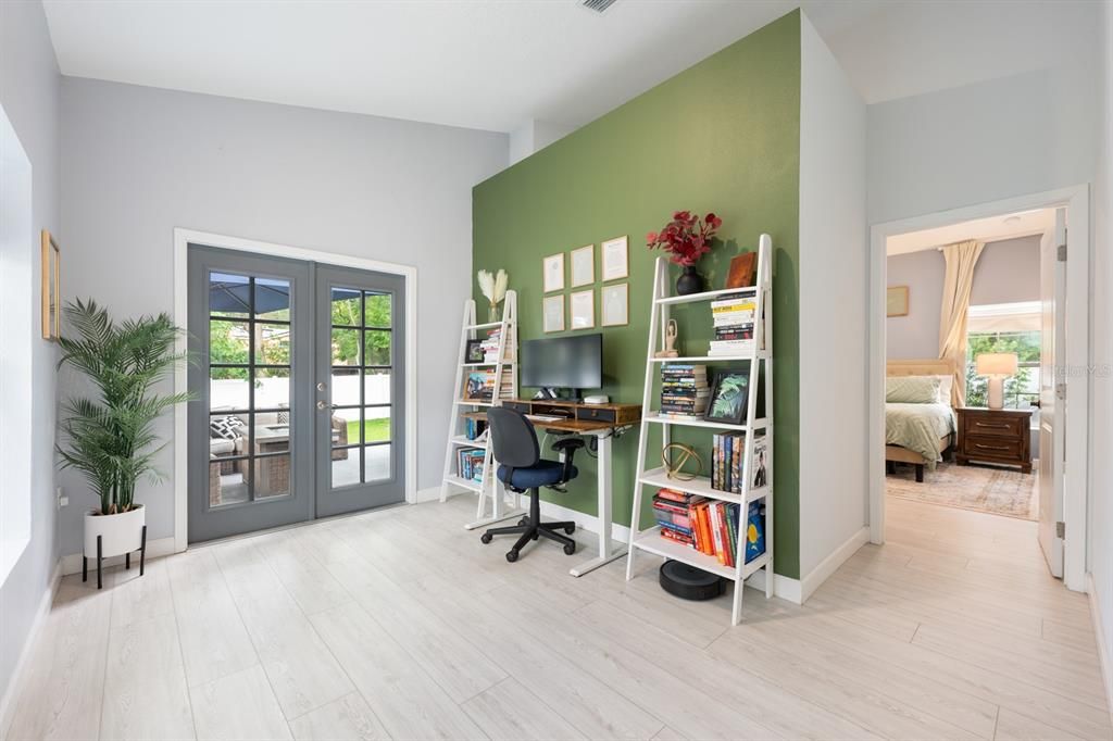 A BONUS ROOM, ideal for a home office or creative space, opens through FRENCH DOORS directly onto the back patio, enhancing your indoor-outdoor lifestyle.