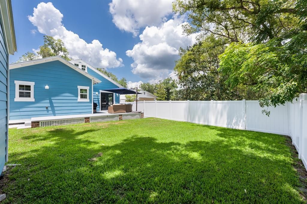 The fully fenced backyard features vinyl fencing, a handy storage shed, and plenty of room to enjoy outdoor living.