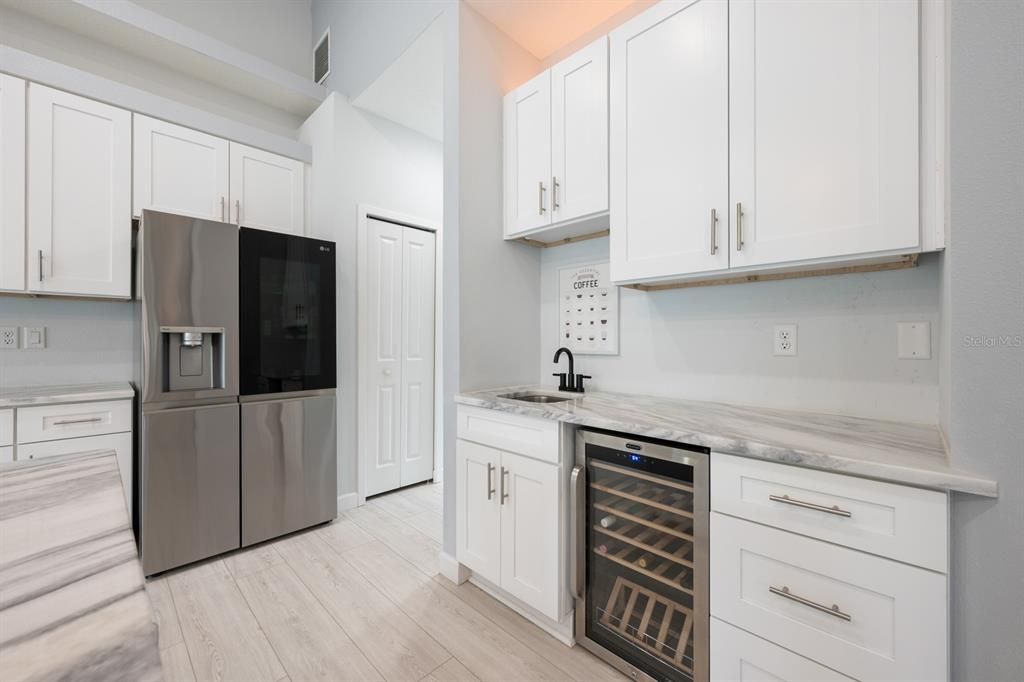 Sleek cabinetry, granite countertops and a built-in WINE REFRIGERATOR make this Kitchen ideal for entertaining.