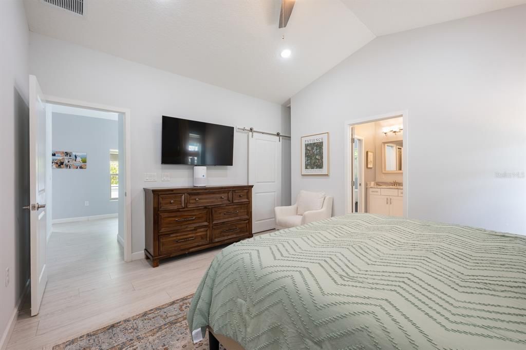 Modern Barnyard doors hide the Walk-in closet in the Primary Suite.