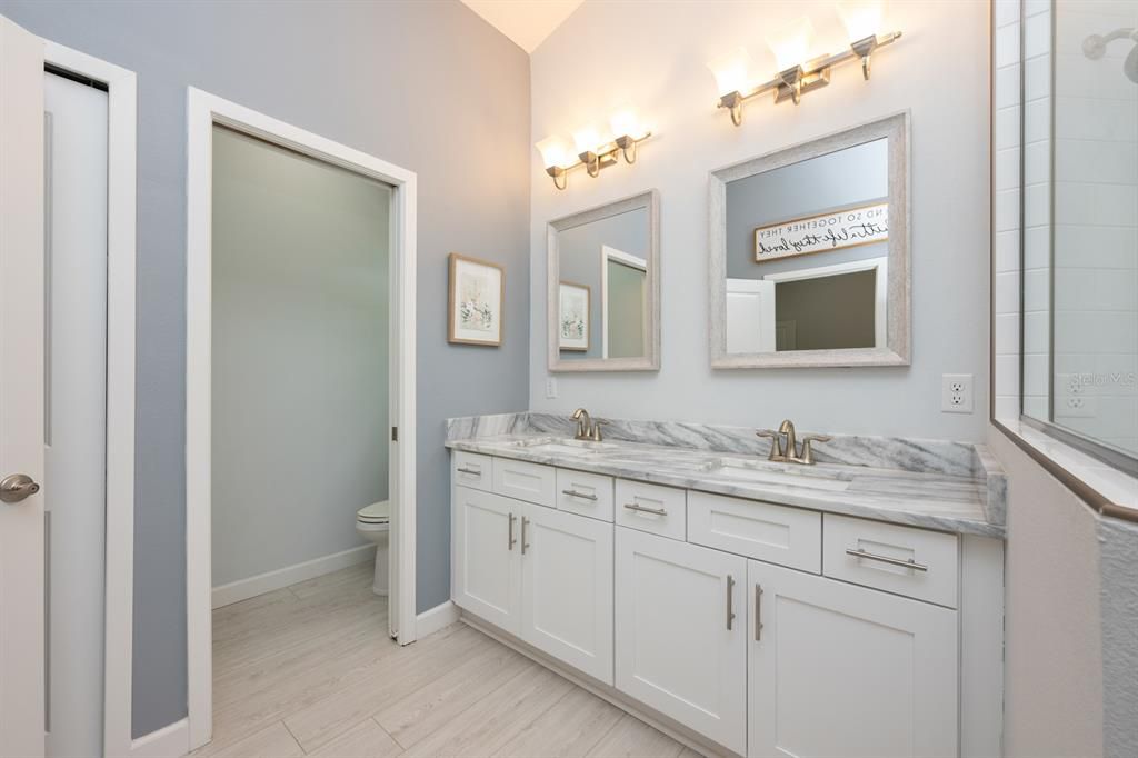 The Primary EN SUITE BATHROOM contains a private water closet, dual sinks, walk-in shower and plenty of space to unwind.