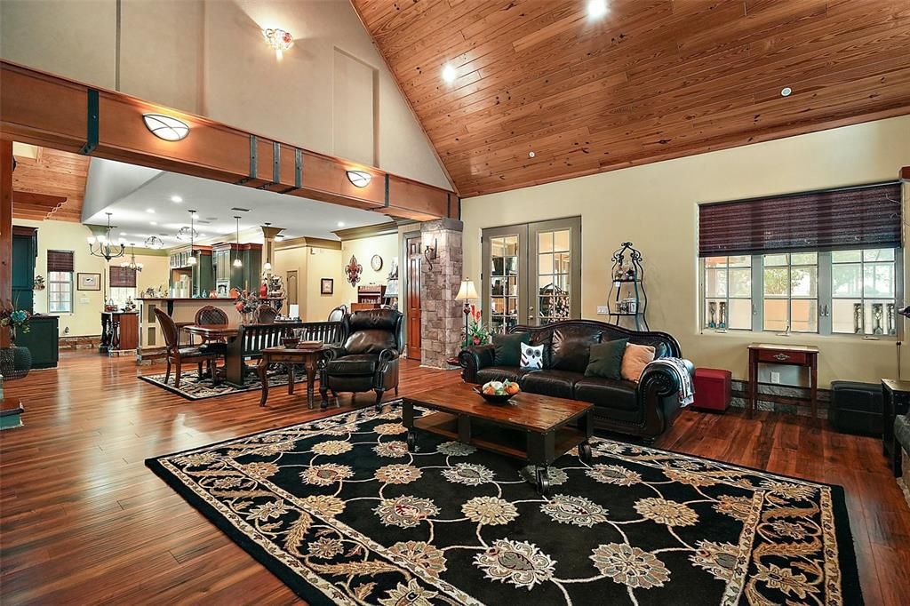 This inviting open-concept living and dining space seamlessly blends warmth and sophistication