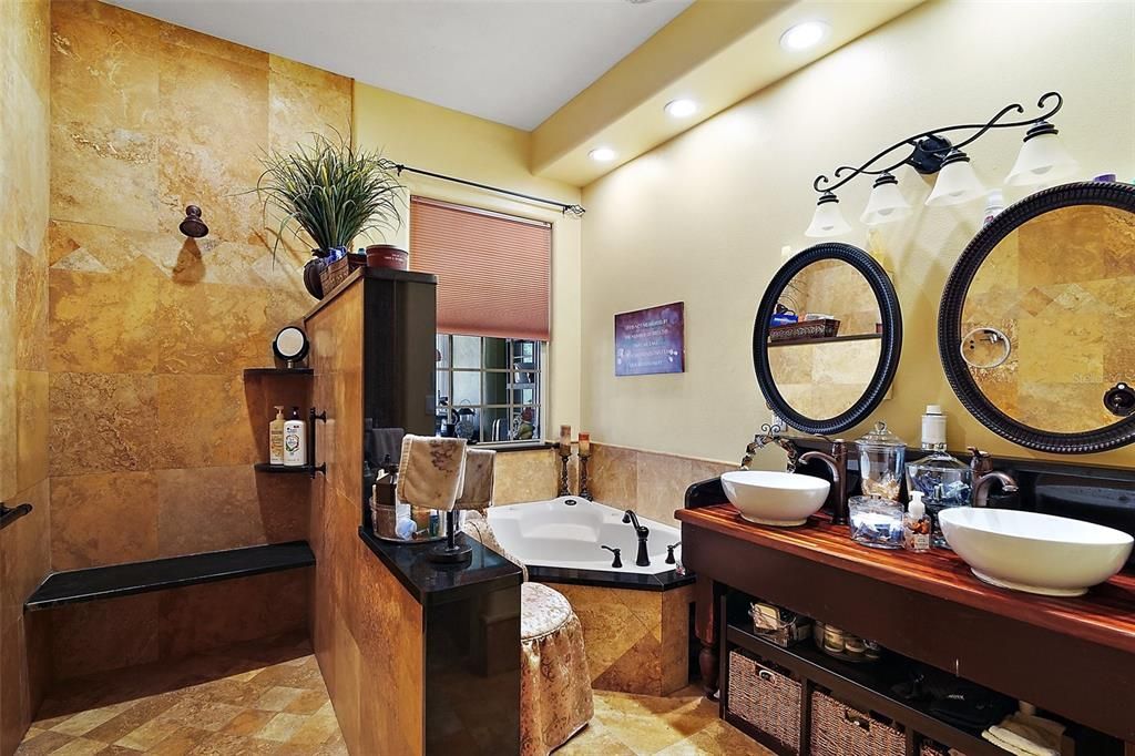 primary bathroom, shower seat, multiple shower heads, dual bowl sinks and jetted garden tub