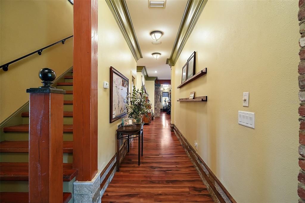 12" baseboards with wood and stone accents, this is the  hallway from the foyer