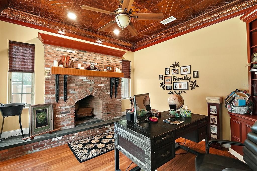 front office/den with authentic brick fireplace, cooper look ceiling tiles which are just some of the distinctive features of this home.