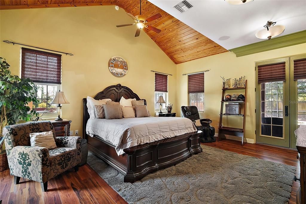 Primary bedroom with tongue and groove vaulted ceilings and french doors to the lanai