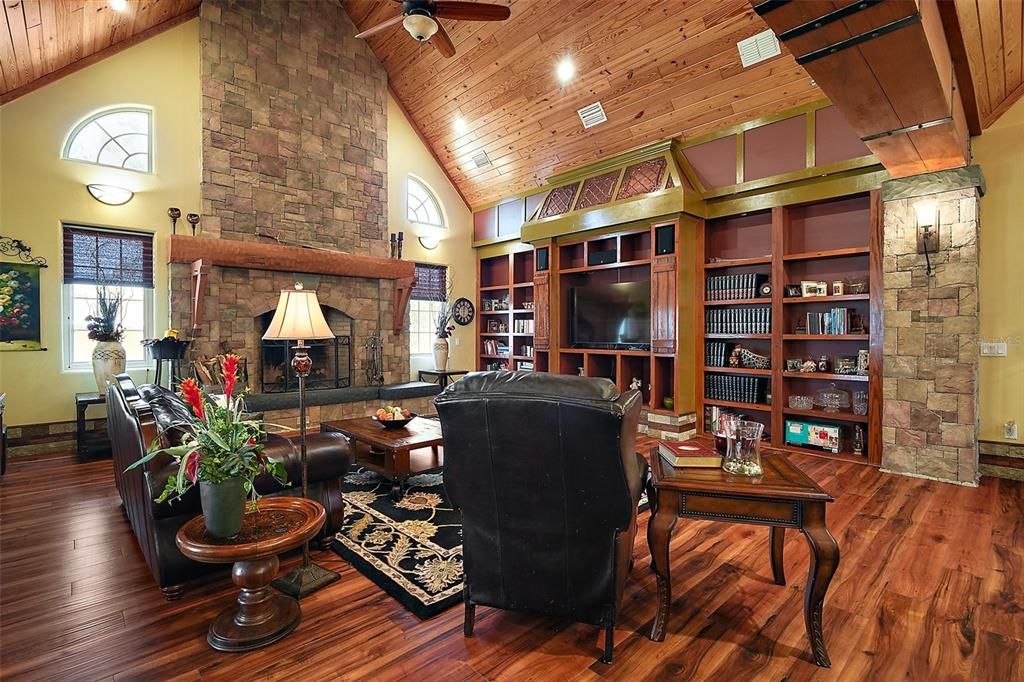 Receased lighting, arched windows, luxury vinyl plank flooring and built in bookcase/secret door.