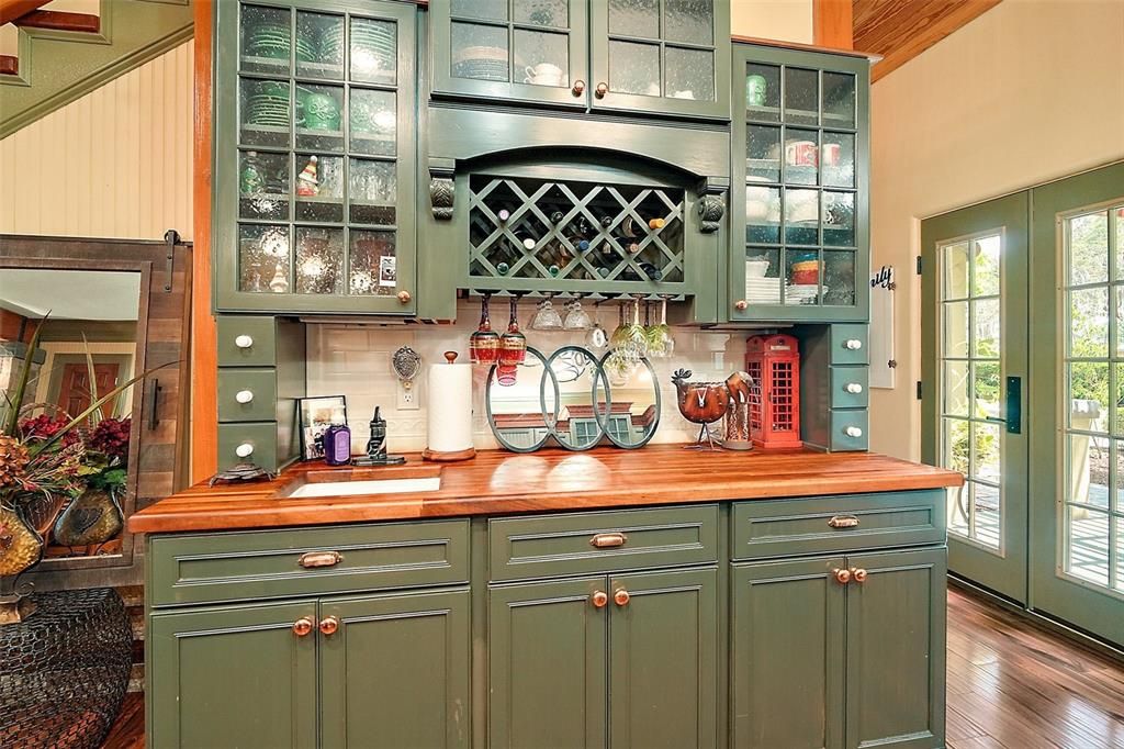 built -in china cabinet and wet bar as part of the kitchen space.