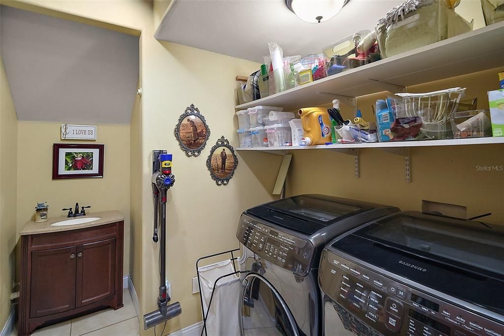 inside utility room with vanity sink plus storage on both sides