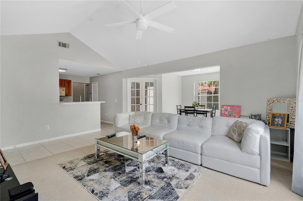 The open floor plan where you can see the kitchen, dining room and a bedroom