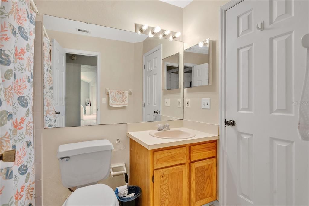 Attached guest bath with entrance into bedroom 2 and hallway