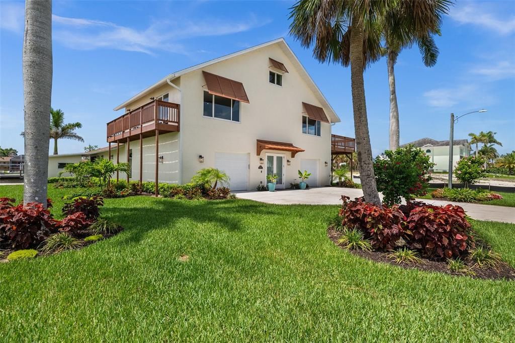 Lush tropical landscaping surrounds the property