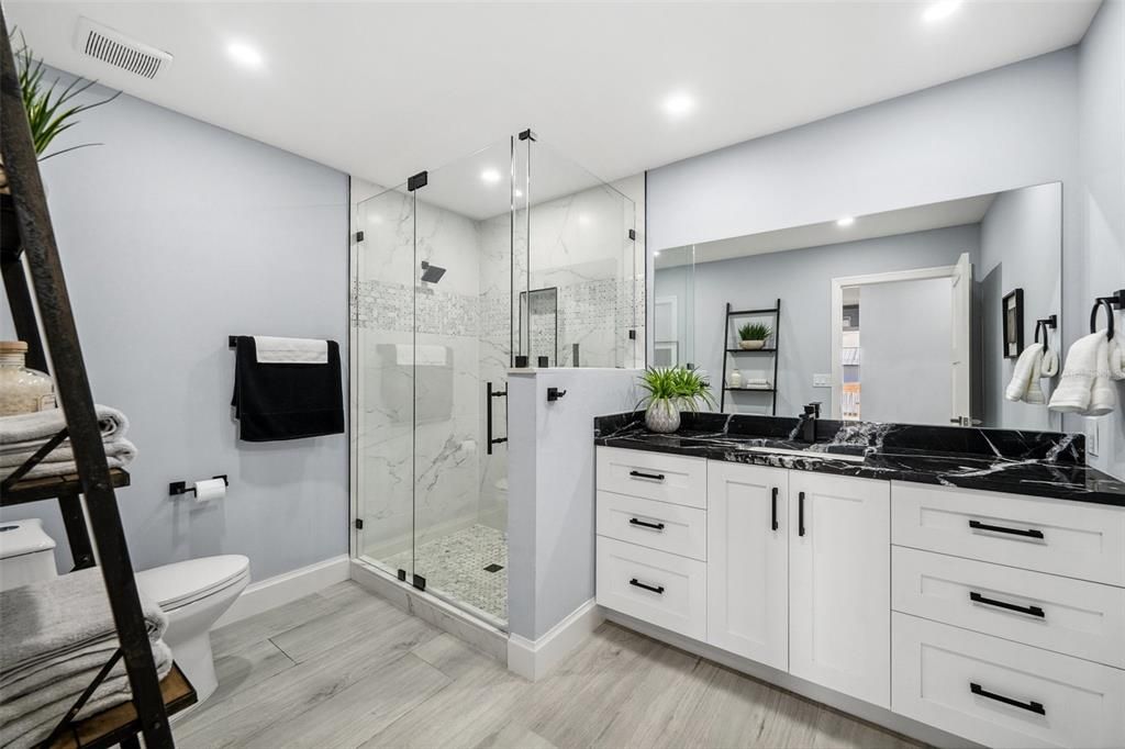 Guest bathroom with tiled, glass-walled shower