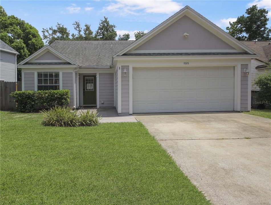 Front of home with nicely kept lawn and hedges.  Home has 2 car garage, laundry in garage.  Large bay window on left is in the breakfast nook inside the kitchen.