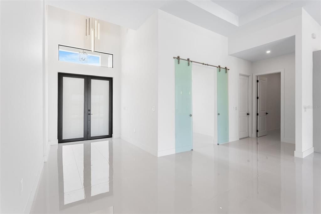 Enter through the COVERED FRONT PORCH and GRAND DOUBLE DOORS into a SOARING 16-FT FOYER, where a NEUTRAL PALETTE OF WHITE, LIGHT GRAY, and CASHMERE WELCOMES YOU HOME!