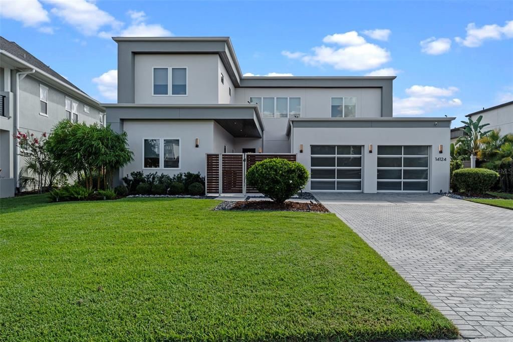 Welcome Home to your stunning modern home that features sleek architectural lines, a spacious two-car garage with frosted glass doors, and pristine landscaping that enhances its exceptional curb appeal!