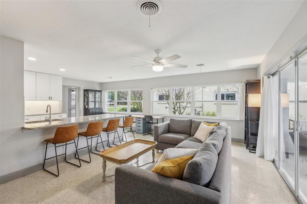 Family room with an abundance of windows features sliding doors out to the covered screened patio