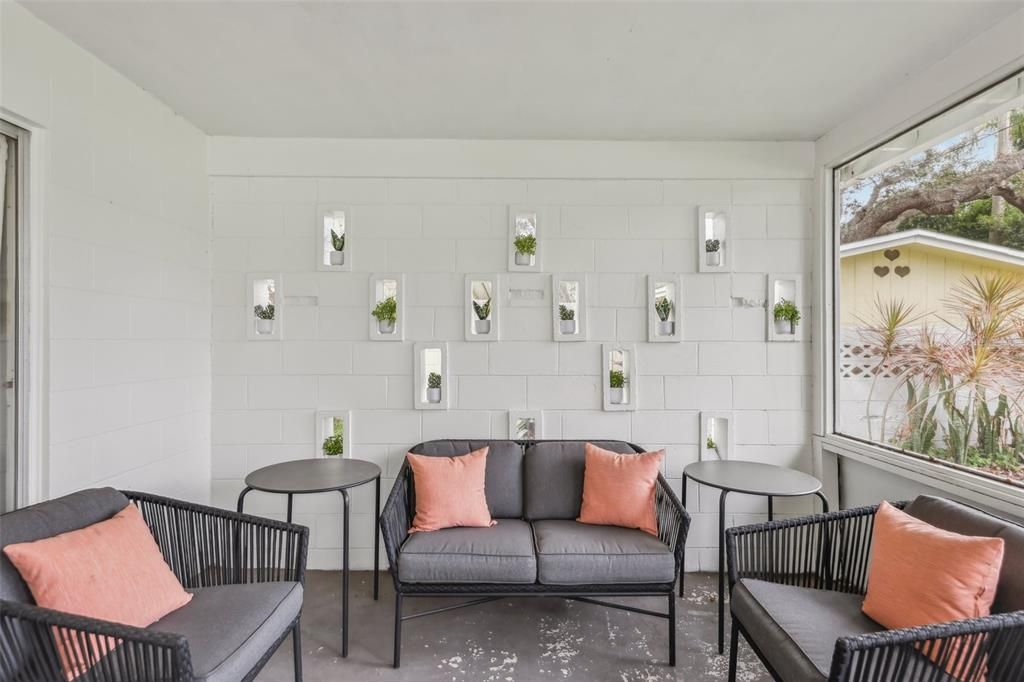 Unique concrete wall in screened patio with decorative inserts
