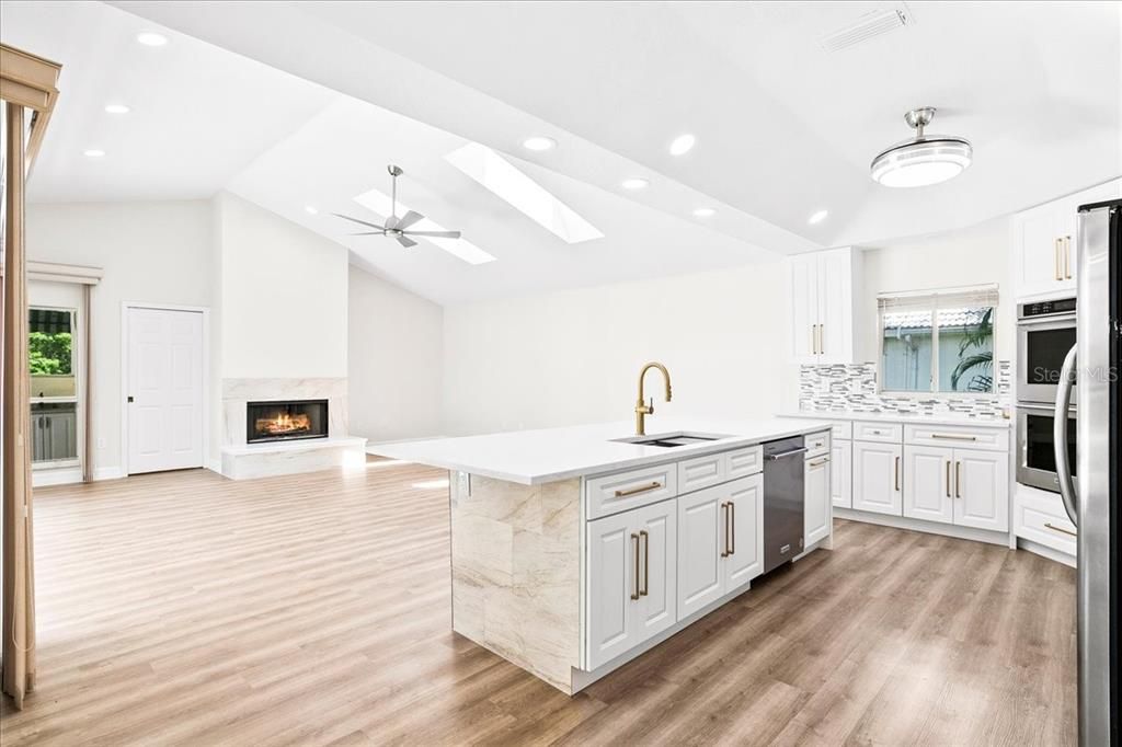Casual and elegant, the family room is open to the kitchen.  Enjoy the natural light pouring in from the skylights.