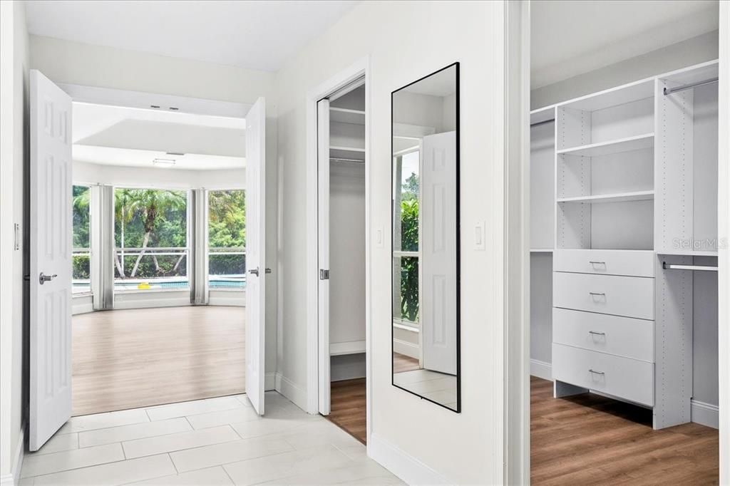 Primary bedroom offers a spacious walk-in closet with custom organizational system.