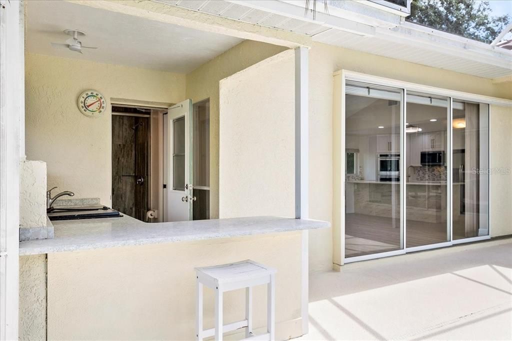 Outdoor kitchen and seating is an entertainer's dream.