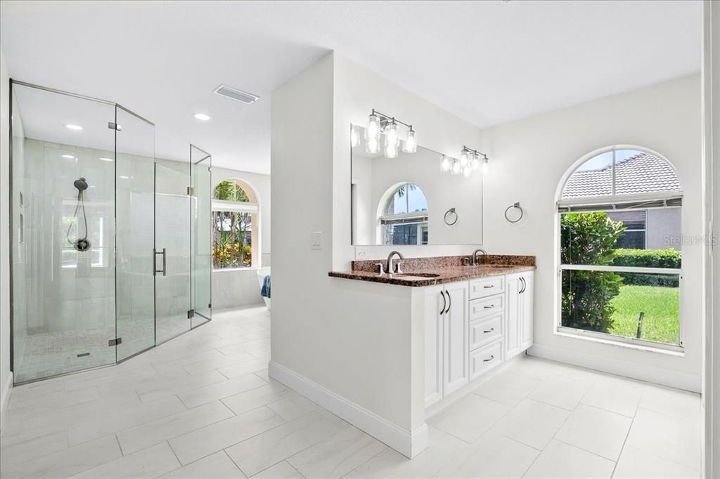 Spacious ensuite bath offers dual vanities, stand alone shower and soaking tub. New floor to ceiling tile in shower.