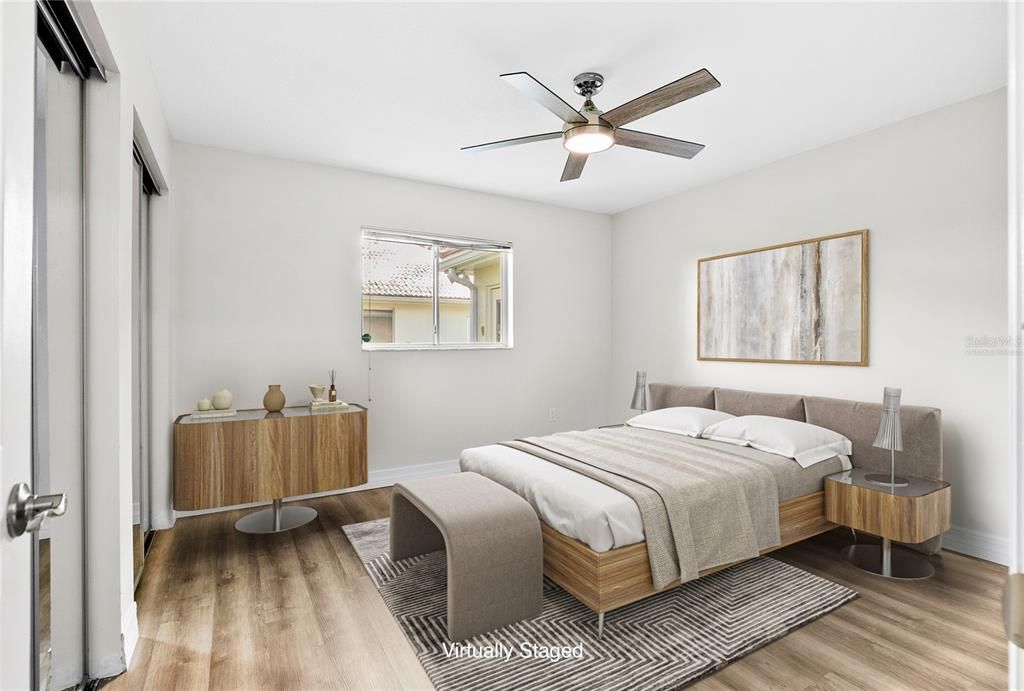 Bedroom 2 has an ensuite bathroom with a shower and tub. (Virtually Staged)