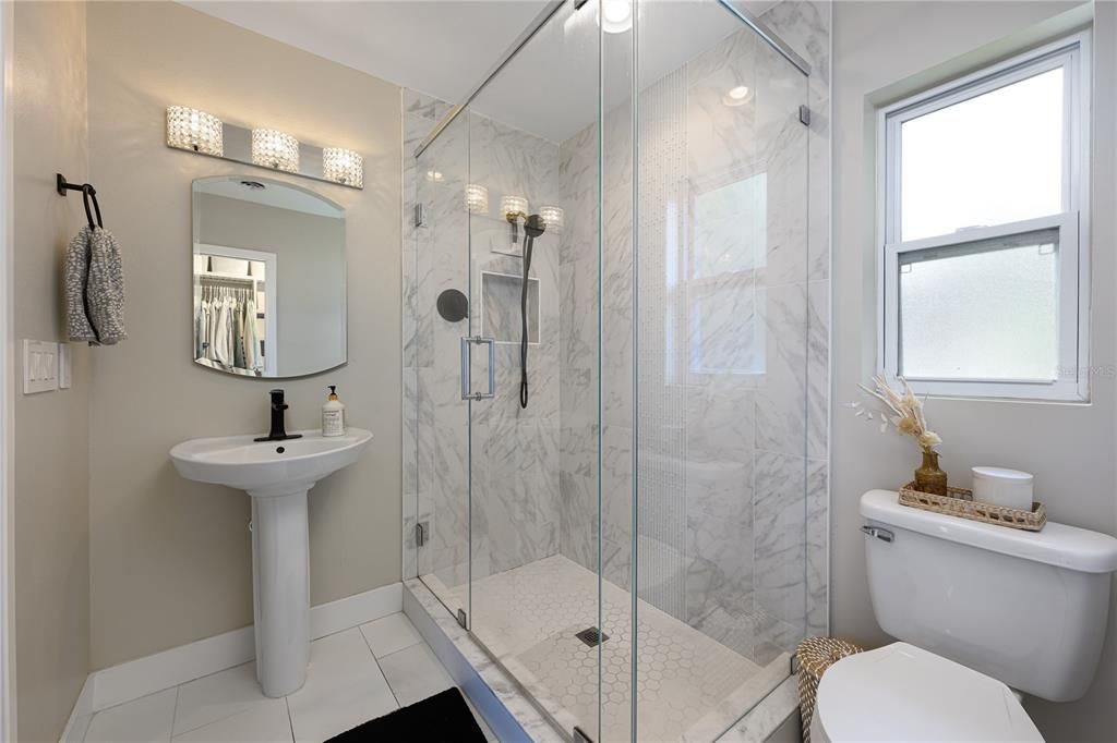 Primary bath with marble shower. Heated floors.