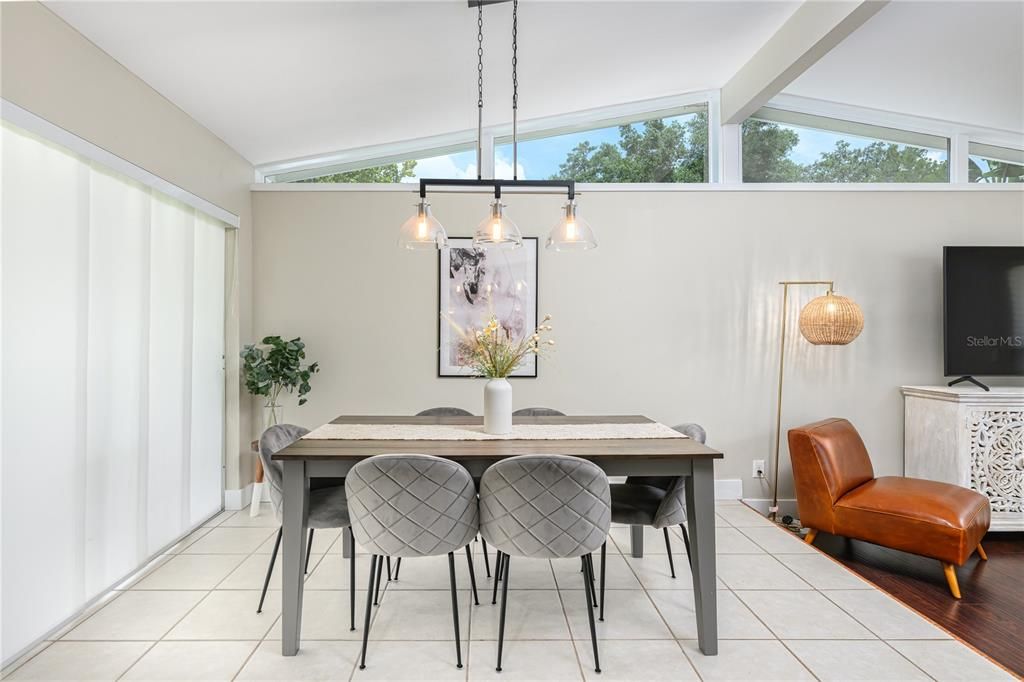 Dining Room with elevated windows and sliding door leads to patio