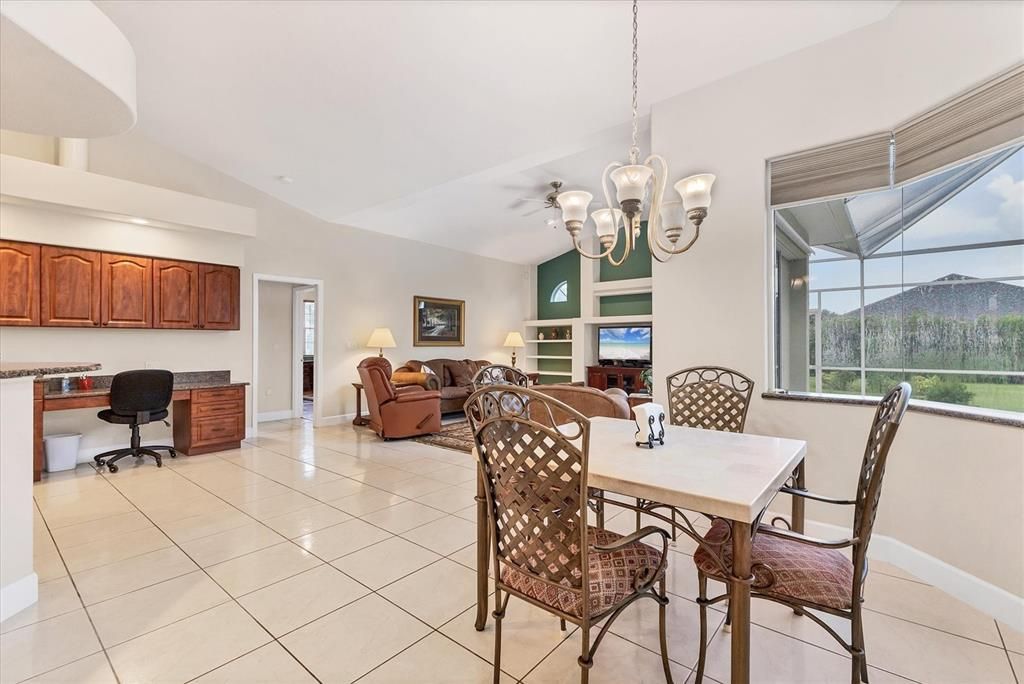 ANOTHER VIEW OF BREAKFAST NOOK AND FAR LEFT IS BUILT IN DESK SYSTEM AND FAMILY ROOM AT REAR, DOORWAY IN BETWEEN TO GUEST ROOMS