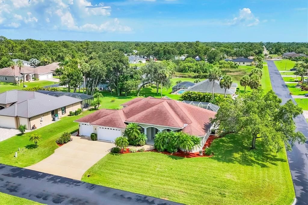 AERIAL VIEW OF FRONT OF HOME AND CORNER LOT