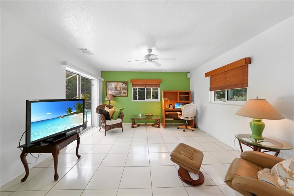 Spacious 20x11 flex room with sliders to the pool—once used as a third bedroom.
