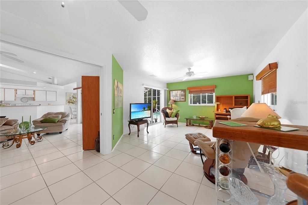 Abundant natural light, three windows, and large pocket doors to the living room.
