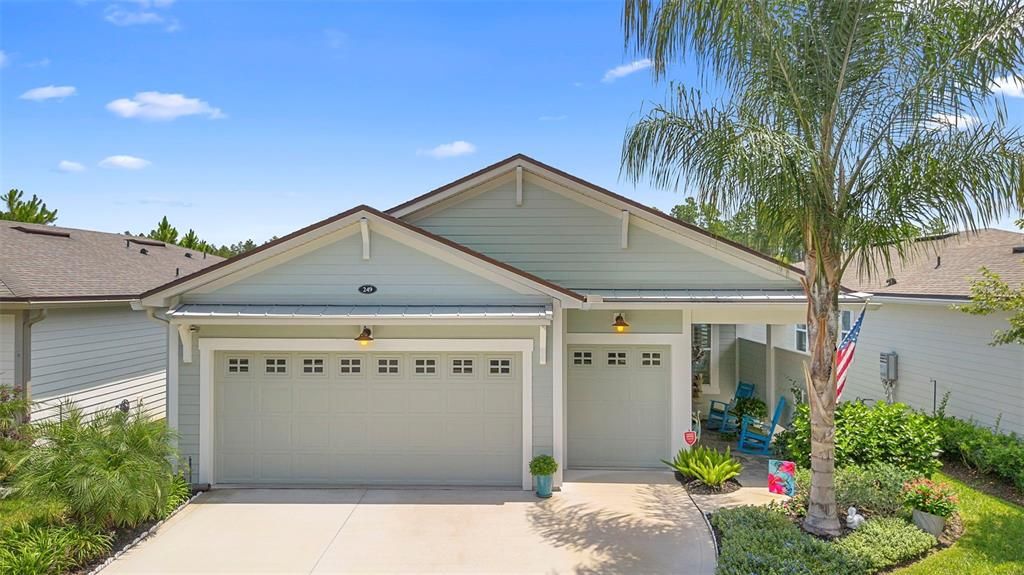 The front elevation showcases a striking 3 door garage paired with a custom-designed breezeway, adding both architectural charm and enhanced privacy. This thoughtful entryway sets the tone for the home’s unique character and provides a seamless transition from exterior to interior living.